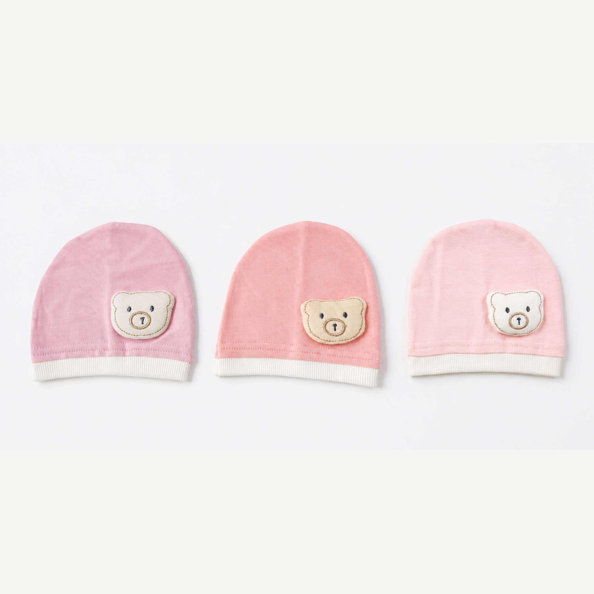 Collection of 3 newborn cotton beanies with teddy bear